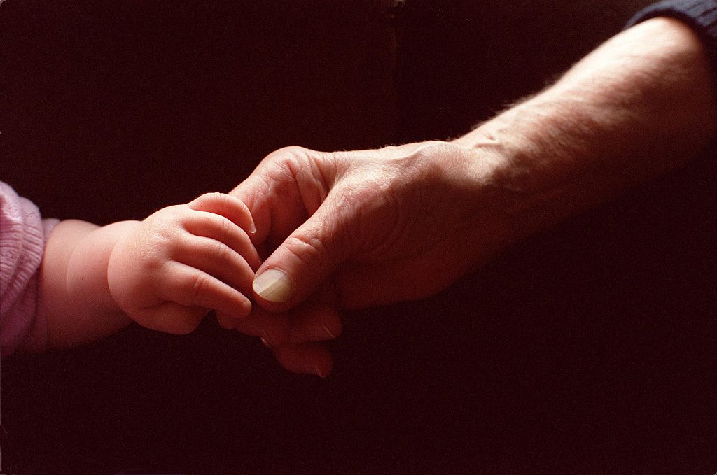 Generic baby holding an elderly persons hand, 1 November 2000. AFR Picture by