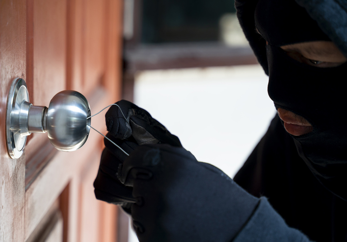 Burglar using special tools to break in a house