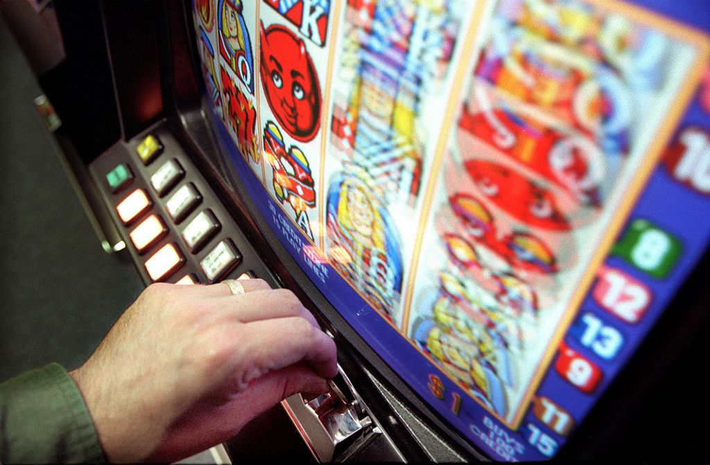 A gambler plays a poker machine, 13 November 2006. AFR Picture by PHIL CARRICK