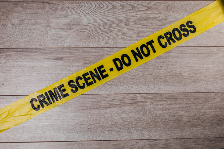 Crime scene tape on wooden background