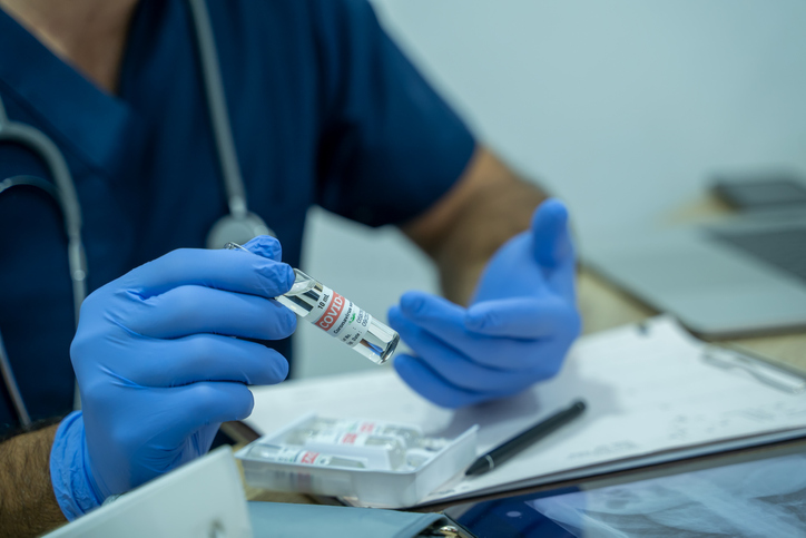 Doctor holding a COVID-19 vaccine,illustration for the new coronavirus pandemic.