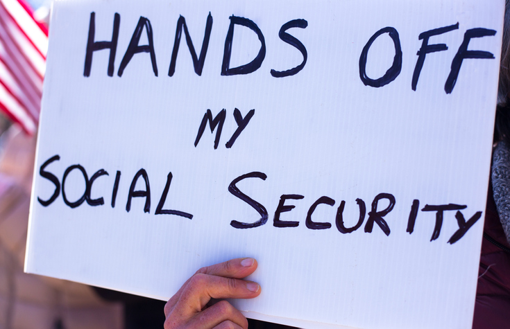 Person Holding Protest Sign: Hands Off Social Security