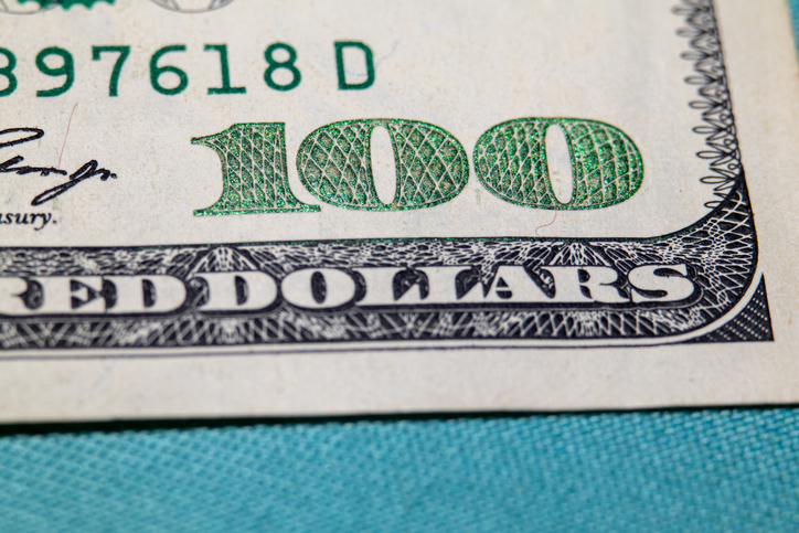 Macro shot of the 100 and RED DOLLARS text on a US one hundred dollar billMacro shot of the 100 and RED DOLLARS text on a US one hundred dollar bill