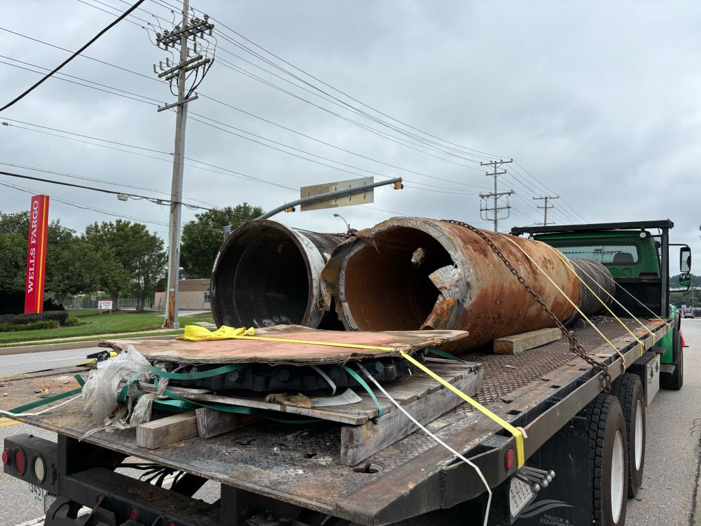 Baltimore County Department of Public Works and Transportation workers remove a section of the broken main on York Road in Cockeysville on Saturday.