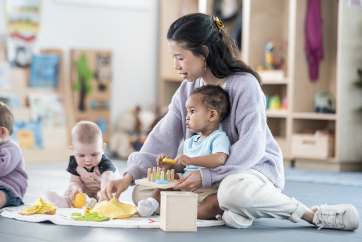 Caregiver Playing With Children in a Daycare or Learning Environment