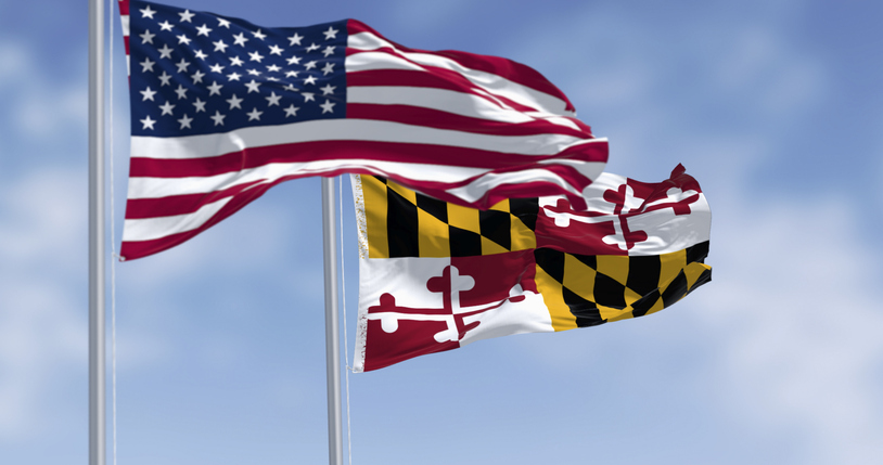 Maryland state flag waving with the american national flag on a clear day